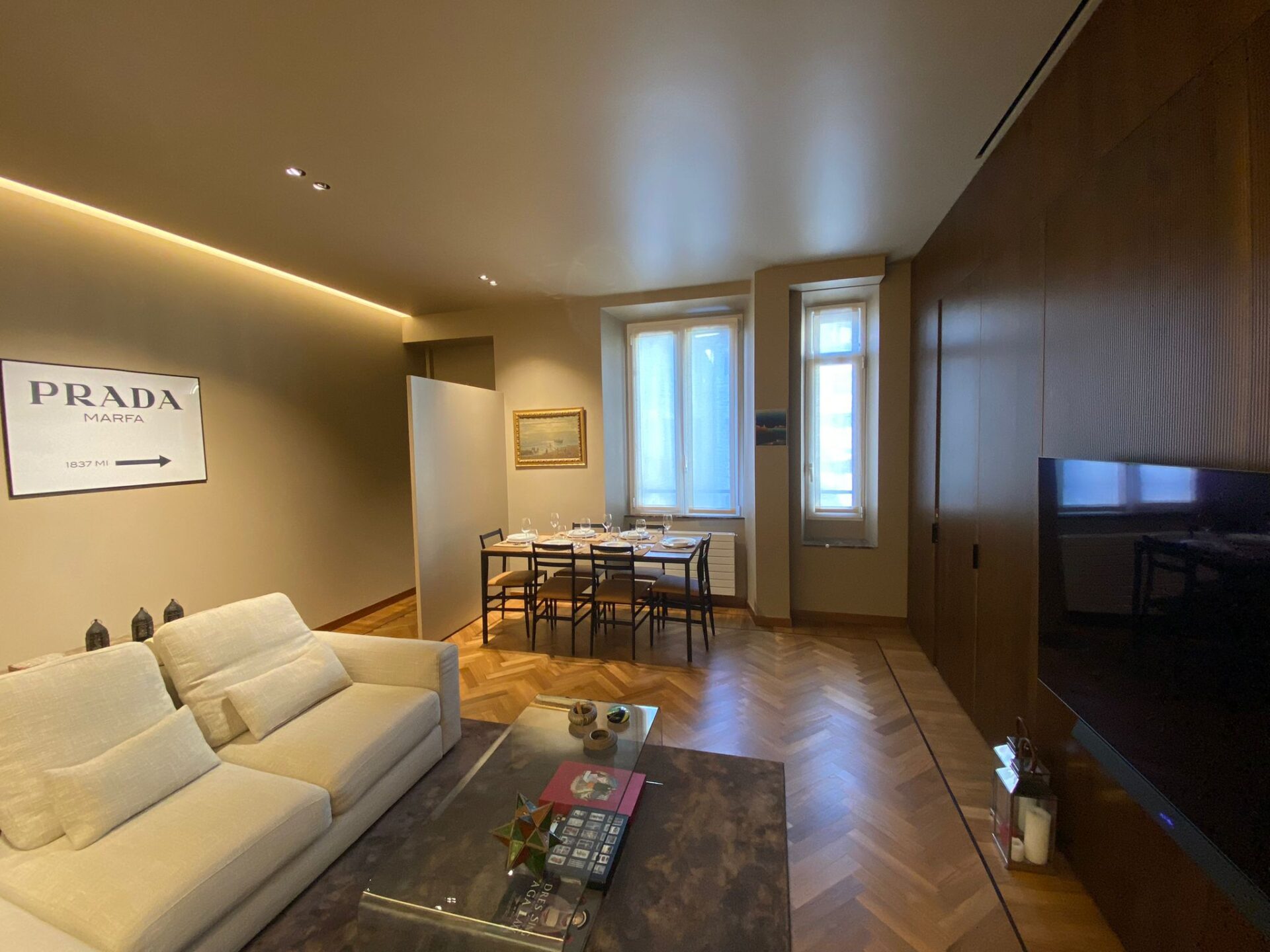 Il divano e il piano tv con la boiserie sullo sfondo